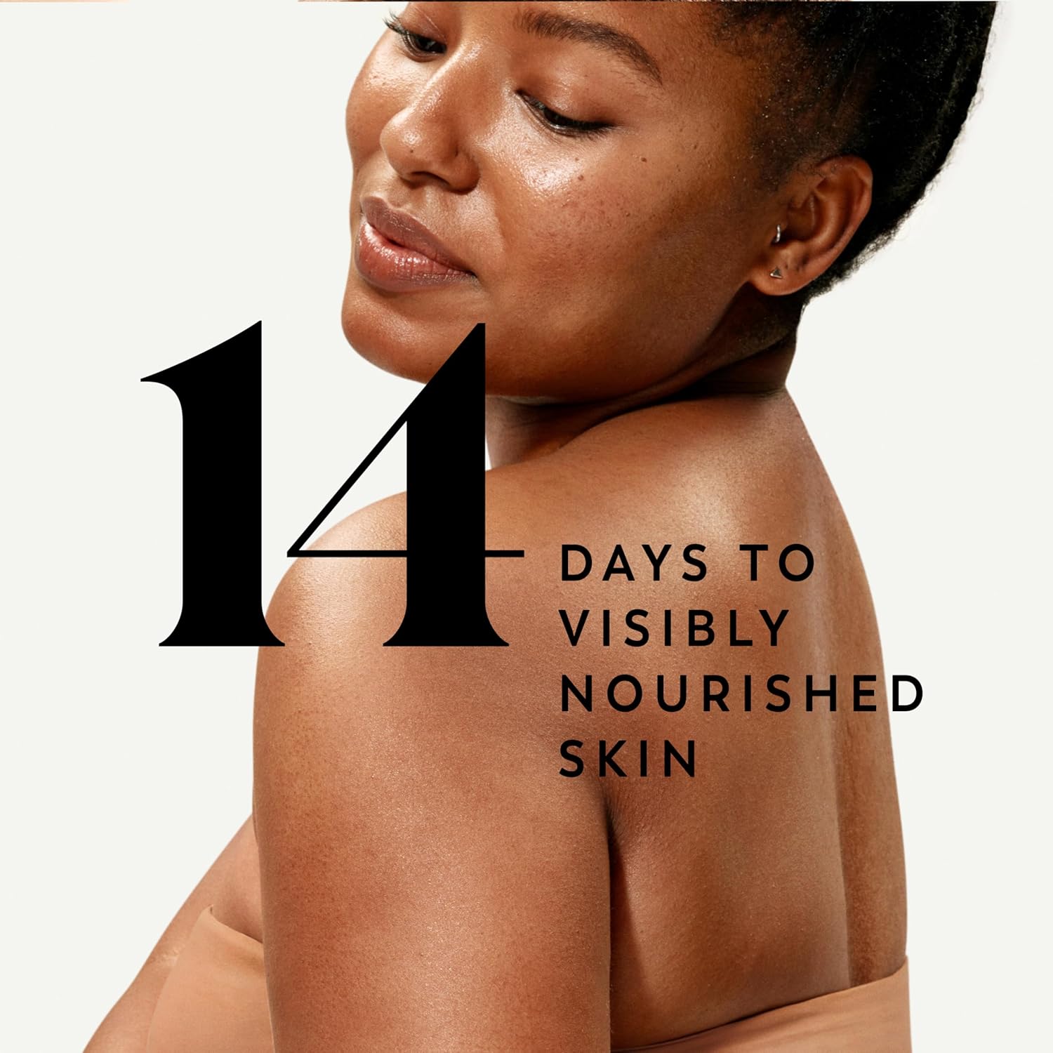 Woman's shoulder with text '14 Days to Visibly Nourished Skin' on a white background