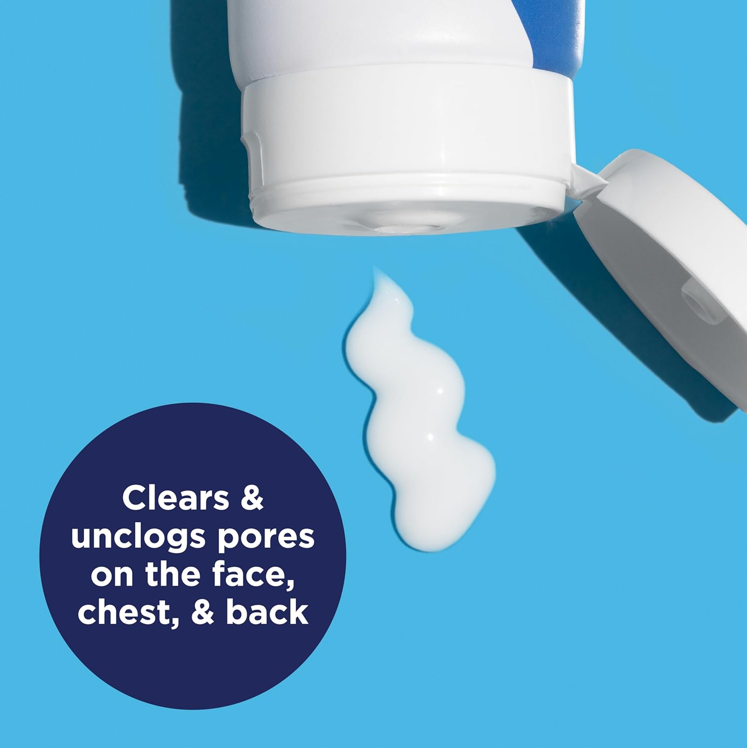 Open bottle of skincare product with white cream on a blue background