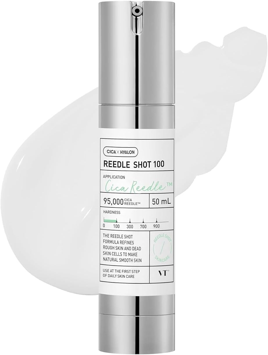 A sleek silver cylindrical bottle of VT CICA Reedle Shot 100 Anti Aging Face Serum with green text and a white cream smear in the background. The label highlights its hydration focus for youthful skin, mentioning 50 ml and featuring a scale indicator.