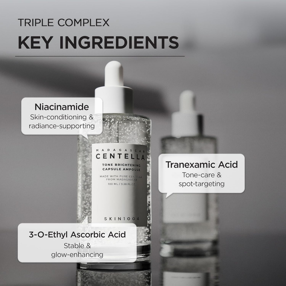 Two skincare bottles with key ingredients labeled on a gray background