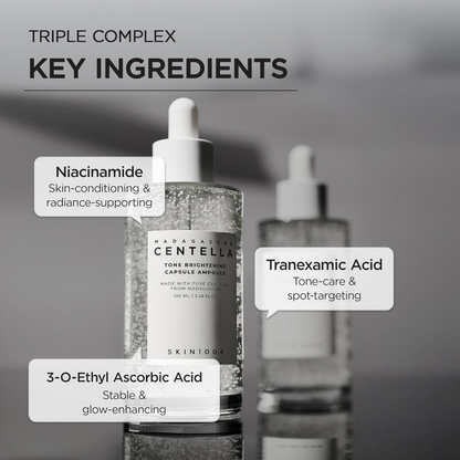 Two skincare bottles with key ingredients labeled on a gray background