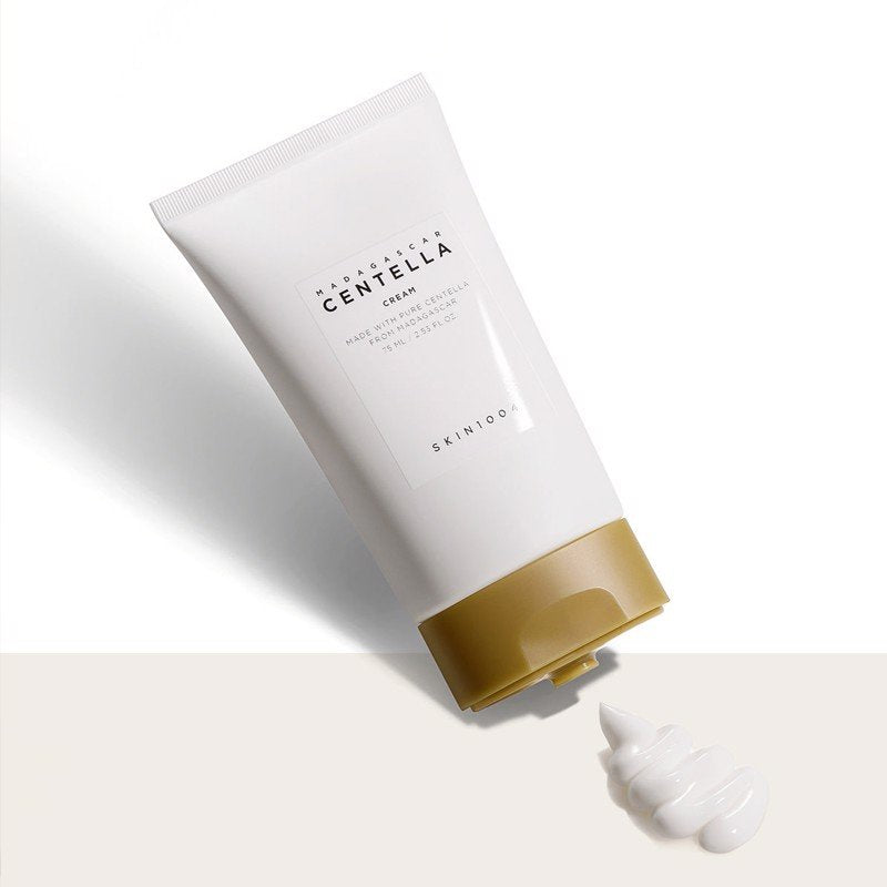 A close-up shot of the cream's texture, with a small amount dispensed from the tube onto a smooth surface, showcasing its rich and creamy consistency.