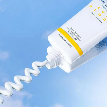 Squeeze of sunscreen cream from a tube with a blue gradient background