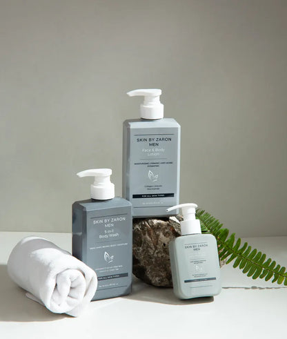 Three bottles of 'Skin by Zaron' products on a neutral background with a towel and leaf.