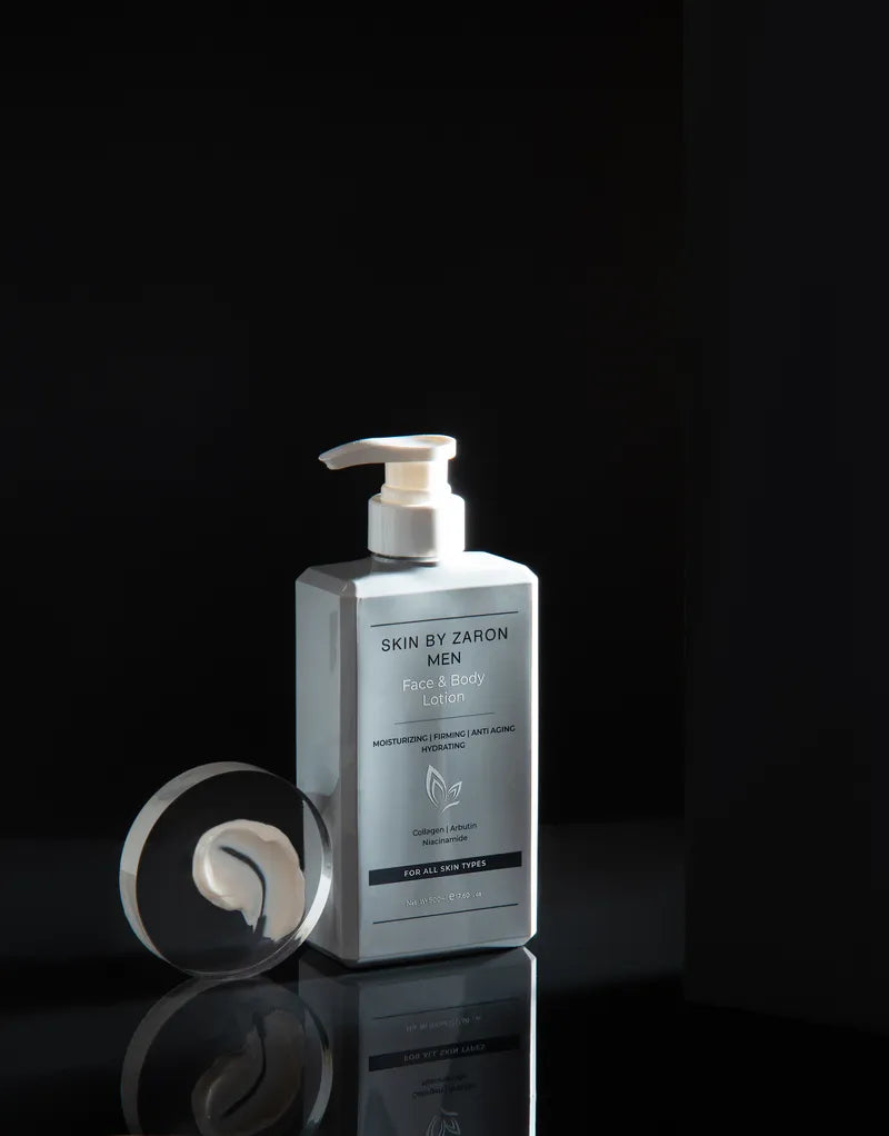 Silver bottle of 'Skin by Zaron' body lotion on a black background