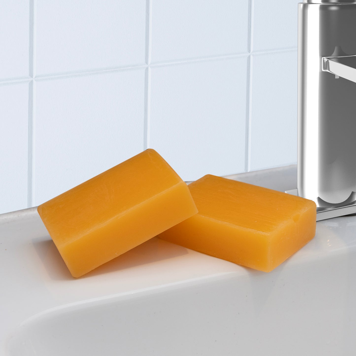 Two MOSANNE Kojic Acid Dark Spot Remover Soap bars, famous for brightening skin, sit on the edge of a white sink against pristine tiled walls. A metallic soap dispenser adds elegance from the right.