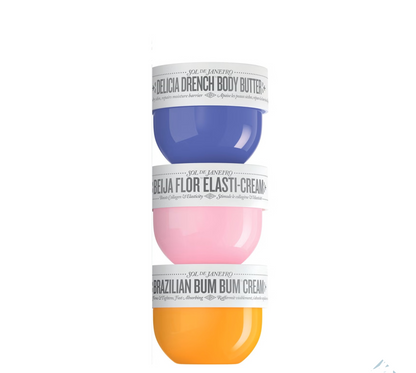 Three cosmetic jars with different colored creams on a white background