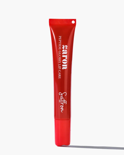 A red squeeze tube of Zaron Saffron Peptide Glossy Lip Care standing upright on a light gray background with a soft shadow.
