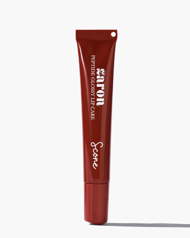 A single tube of Zaron Peptide Glossy Lip Care in a deep reddish-brown color, featuring white text, shown on a clean white background with a soft shadow.