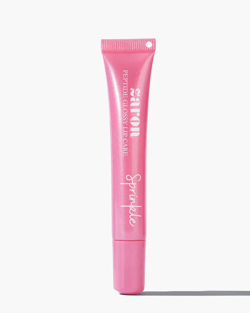 A pink tube of Zaron Glossy Lip Care, shown vertically against a clean white background with a soft shadow.