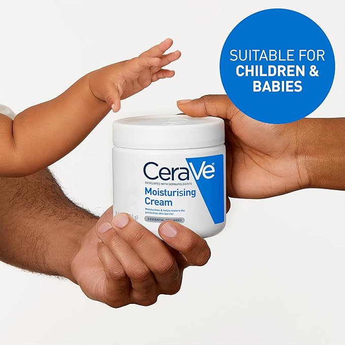 Two adult hands hold a babys hand reaching for a white jar of CeraVe Moisturizing Cream for Normal to Dry Skin with Ceramides - 454g. A blue circle with the text SUITABLE FOR CHILDREN & BABIES is on it, set against a plain white background.