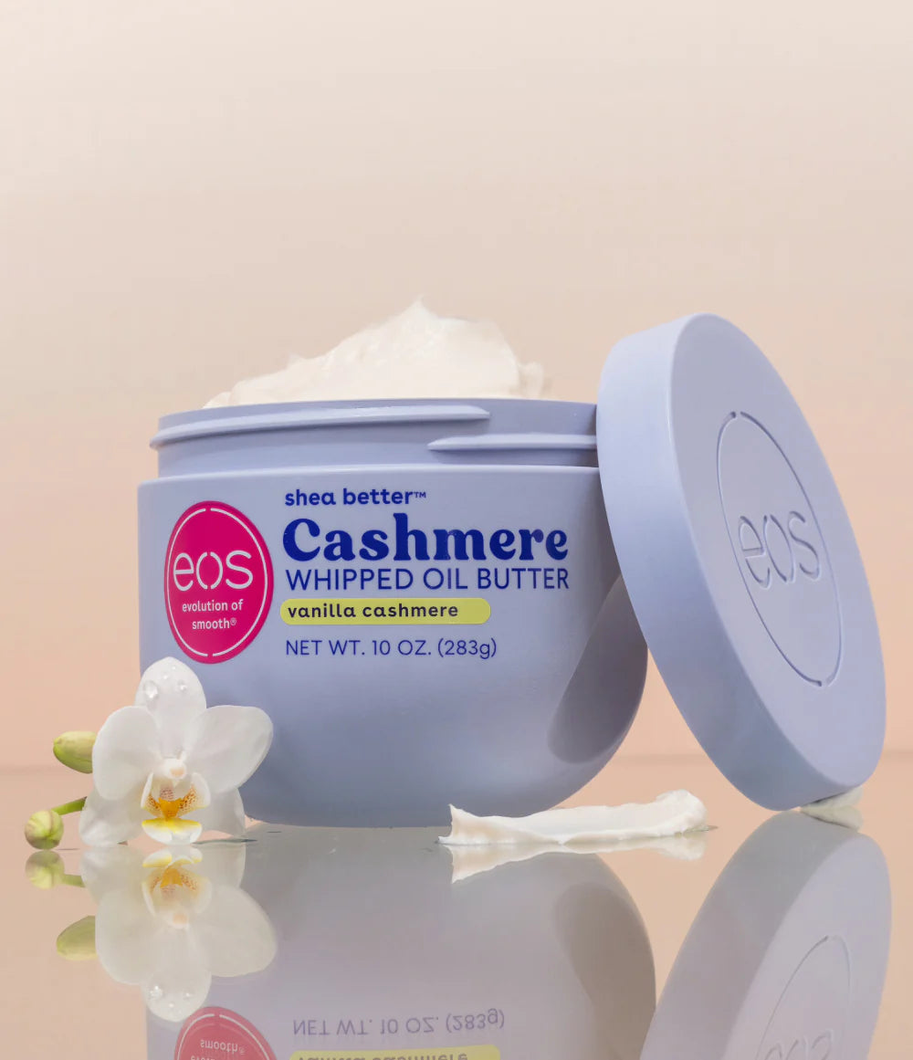 Eos Cashmere Whipped Oil Butter jar with a white orchid on a beige background