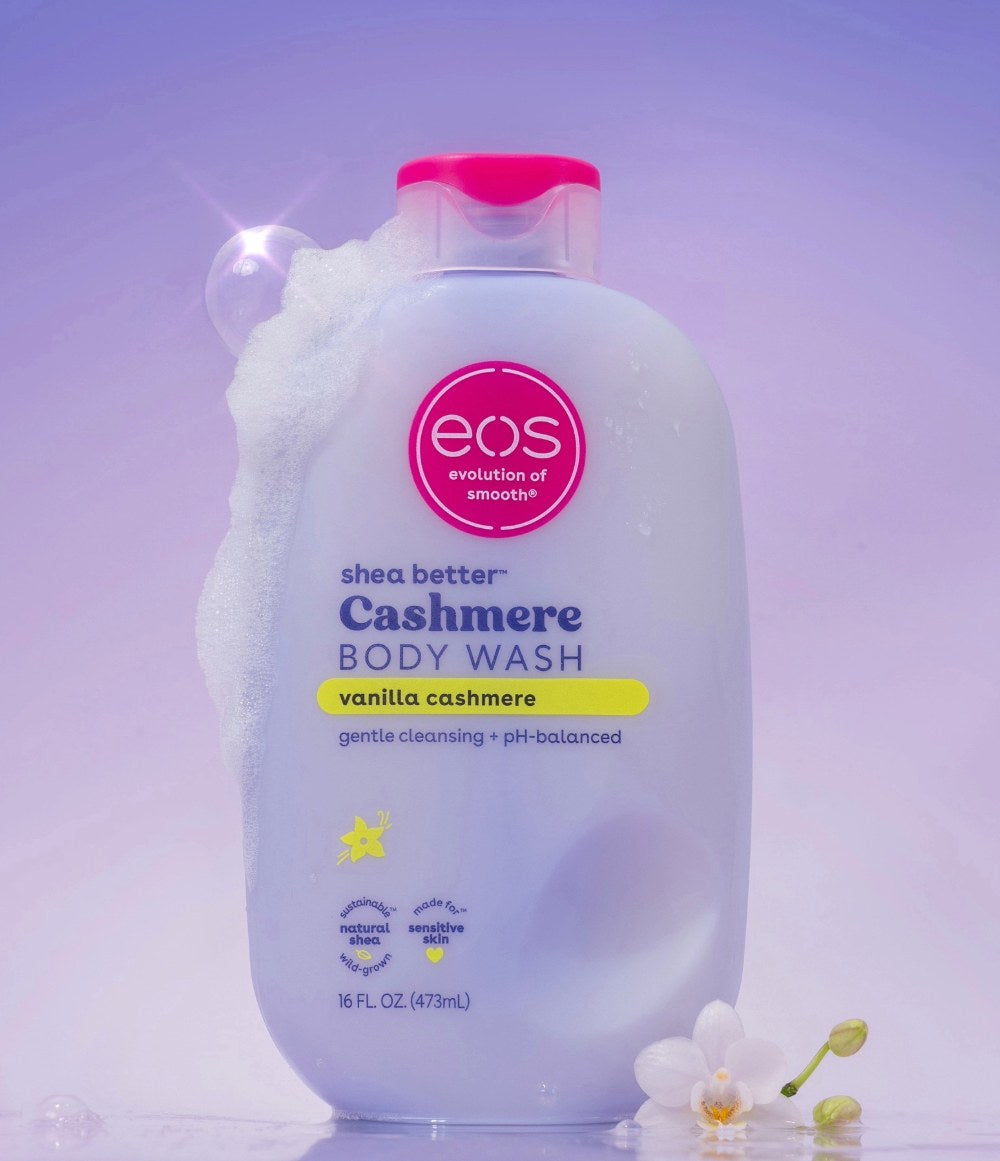 eos shea butter Cashmere body wash bottle with pink cap on a light purple background