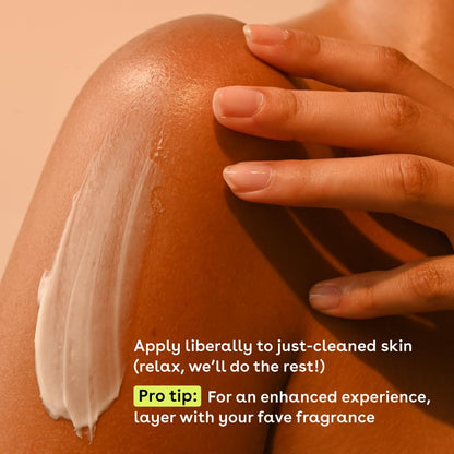 A close-up of a shoulder with eos Shea Better 24H Moisture Body Lotion - Jasmine Peach on it. A hand gently rests on top. Text reads: Apply liberally to just-cleaned skin for hydration and sensitive skin care. Pro tip: Layer with your favorite fragrance.