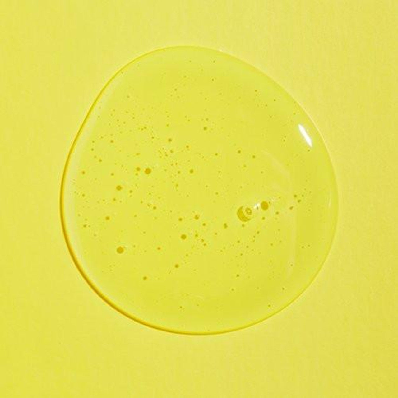 A droplet of translucent, yellow liquid with tiny air bubbles on a yellow background highlights the purity of the vegan cruelty-free COSRX Low PH Good Morning Gel Cleanser 150ml.