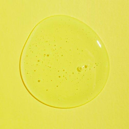 A droplet of translucent, yellow liquid with tiny air bubbles on a yellow background highlights the purity of the vegan cruelty-free COSRX Low PH Good Morning Gel Cleanser 150ml.