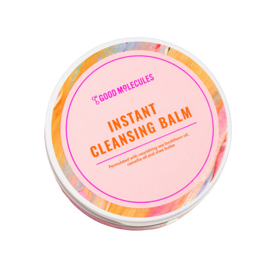 A round Good Molecules Instant Cleansing Balm - 75g features a pink lid with colorful trim and vibrant orange and purple text. Made with sea buckthorn oil, camellia oil, and shea butter, it nourishes the skin while effectively removing makeup.