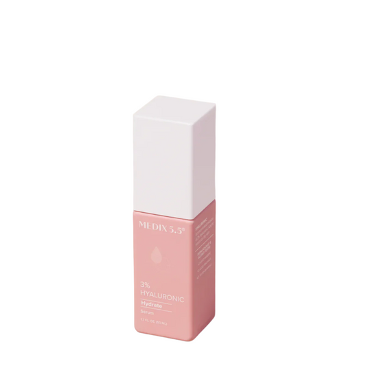 A pink rectangular bottle of Medix 5.5, 3% Hyaluronic Acid Hydrate Serum with a white cap promises hydrated skin. The label features Vitamin B5 and indicates 1.7 fl oz (50 ml).