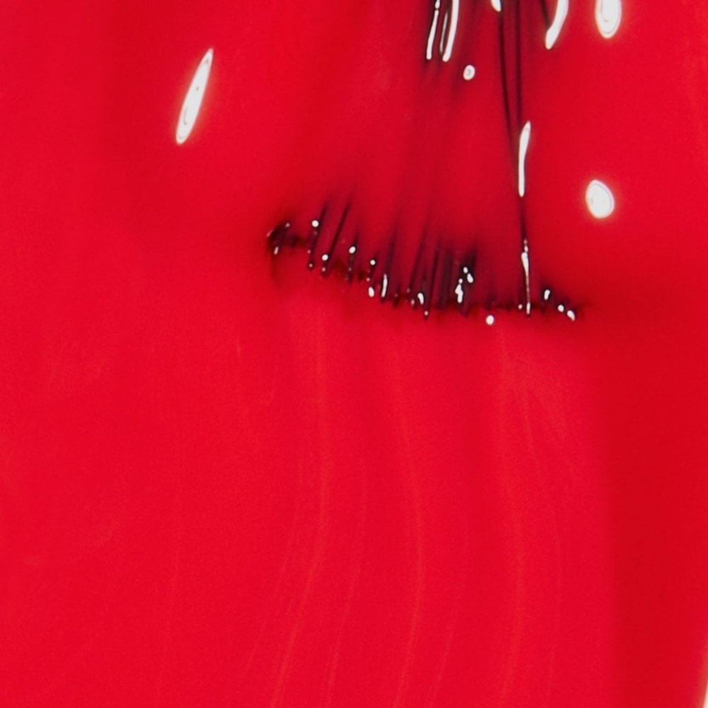 Close-up of OPI Cajun Shrimp Nail Polish 15ml reveals bright red liquid with dark streaks forming an abstract pattern. Its glossy surface and ProWide Brush ensure a chip-resistant finish that reflects light, contrasting with the deep red and black hues.