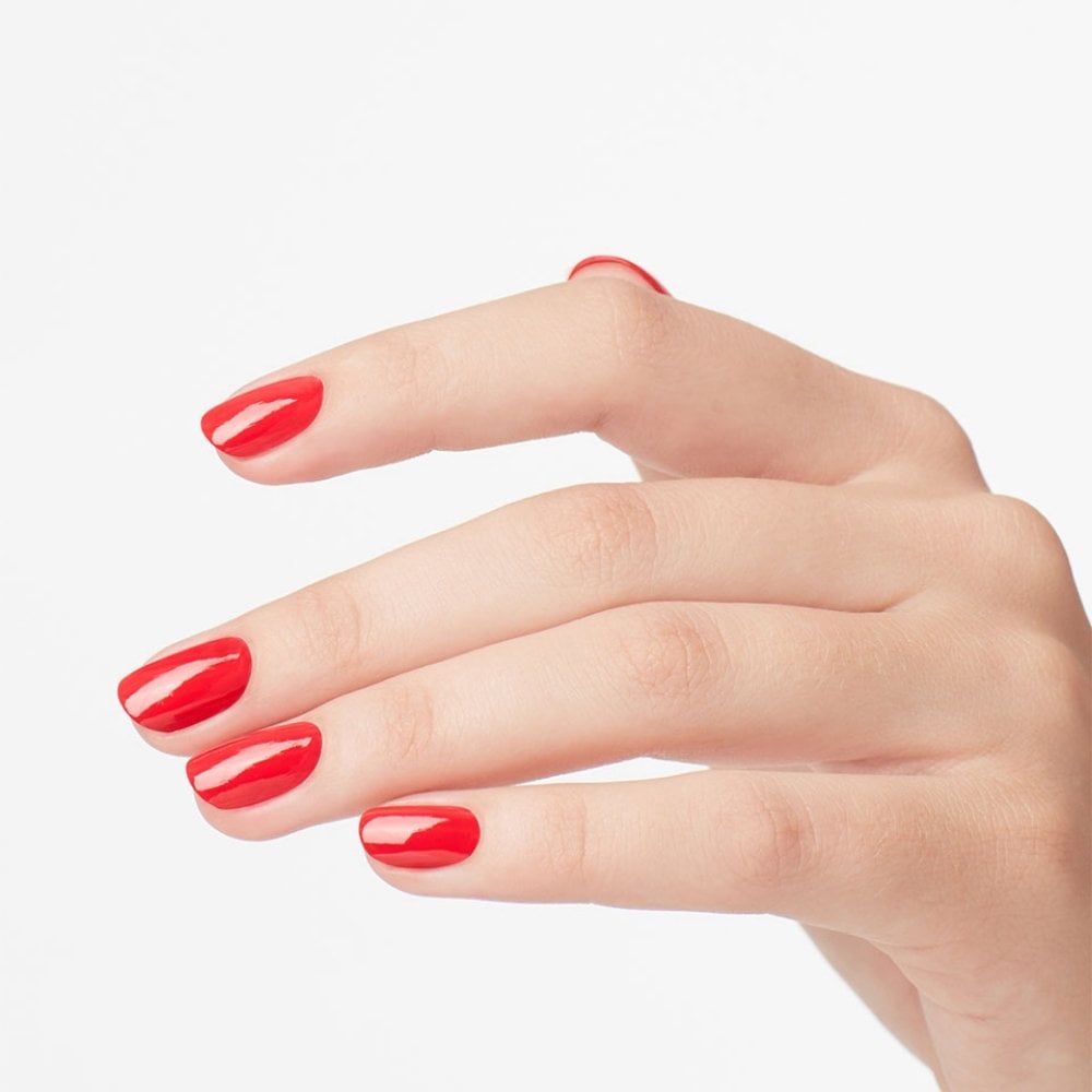 A hand with neatly manicured nails in glossy OPI Cajun Shrimp Nail Polish 15ml is shown. The ProWide Brush creates a smooth finish, and the chip-resistant formula keeps the color vibrant. A plain white background highlights this stunning effect from OPI.