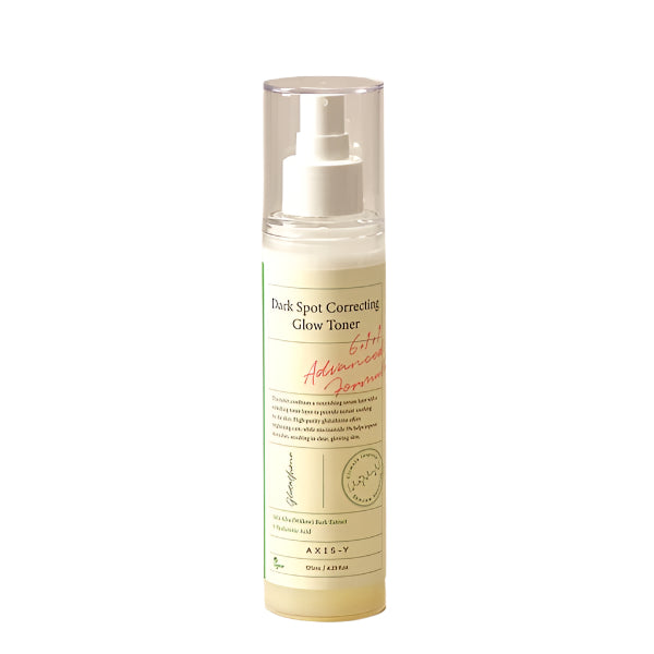 The AXIS-Y Dark Spot Correcting Glow Toner 125ml comes in a cylindrical bottle with a white pump dispenser and clear cap. Its label displays green text, a small illustration, and highlights its 6+1+1 Advanced Formula for tackling dark spots.