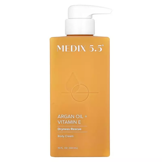 A 15 fl. oz (444 ml) MEDIX 5.5 Anti Aging Body Cream with argan oil, vitamin E, and green coffee extract in an orange bottle features a white pump and Dryness Rescue text.