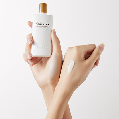 A hand holding SKIN1004 Air-Fit Suncream Plus with a swatch on the skin, showcasing its lightweight, non-greasy texture for UV protection
