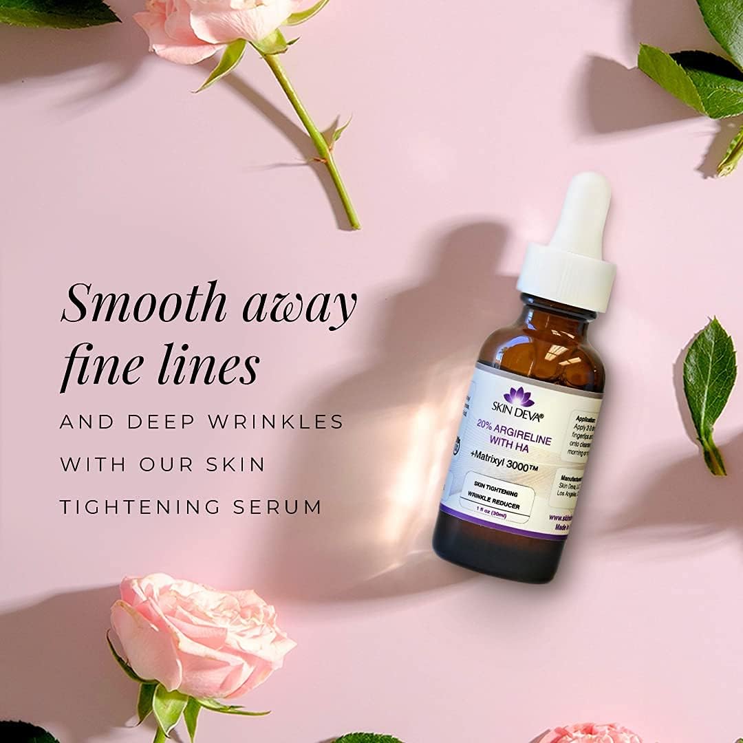 Skincare serum bottle with flowers on a pink background