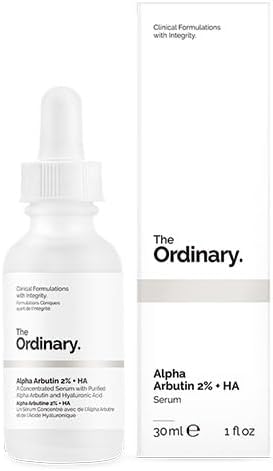 A 30 ml white dropper bottle labeled The Ordinary sits next to its matching box, both displaying the product name Alpha Arbutin 2% + HA designed to target hyperpigmentation. The label reads Clinical Formulations with Integrity.