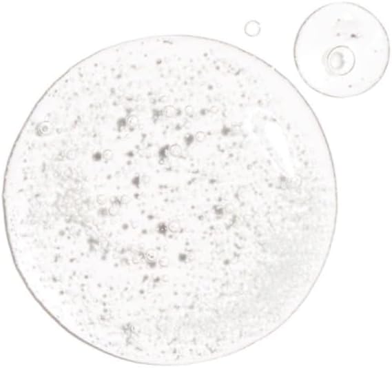 The Ordinary Alpha Arbutin 2% + HA Serum 30ml features clear gel droplets with small bubbles, highlighting its glossy texture on a white background. One large droplet and two smaller ones sit above, all infused with alpha arbutin to reduce hyperpigmentation while hydrating the skin.