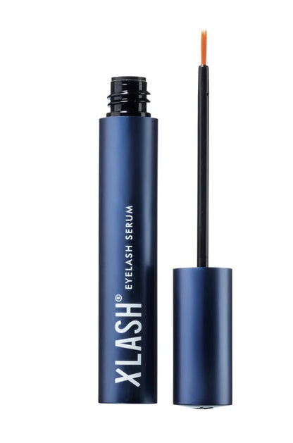 XLASH eyelash serum with applicator on a white background